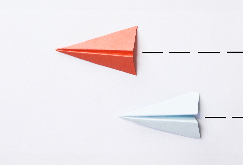 Paper planes representing strategic market entry and time-efficient license transfer